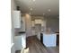 Modern kitchen with white cabinets, stainless steel appliances, and a spacious island at 235 Denham St, Summerville, SC 29486