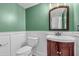 Neat half bathroom with a dark wood vanity and white wainscoting at 2773 Forest Dew Ct, Charleston, SC 29414