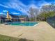 Community pool surrounded by ample patio space, landscaping, and shade structures at 2773 Forest Dew Ct, Charleston, SC 29414
