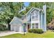 Inviting two-story home with light blue siding, a red front door, and a well-manicured lawn at 2773 Forest Dew Ct, Charleston, SC 29414