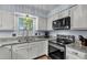Bright kitchen with granite countertops, stainless appliances, double sink, and window view at 2773 Forest Dew Ct, Charleston, SC 29414