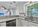 Well-lit kitchen with granite countertops, stainless dishwasher, and view into living area at 2773 Forest Dew Ct, Charleston, SC 29414