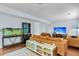 Open-concept living room with wood floors, modern furnishings, and entertainment area at 2773 Forest Dew Ct, Charleston, SC 29414