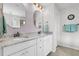 Bathroom with double sinks, granite countertops, and light purple accent wall at 292 Calm Water Way, Summerville, SC 29486
