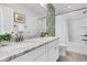 Stylish bathroom with double vanity, granite countertop, and shower with decorative tiling at 292 Calm Water Way, Summerville, SC 29486
