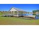 Scenic view of a dock with a white gazebo overlooking a tranquil lake on a bright sunny day at 292 Calm Water Way, Summerville, SC 29486