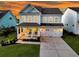 Charming two-story home featuring a welcoming front porch, well-manicured lawn, and a spacious two-car garage at 292 Calm Water Way, Summerville, SC 29486
