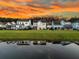 Aerial view of homes reflecting on the lake at sunset at 292 Calm Water Way, Summerville, SC 29486