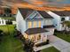 Lovely home with a charming porch, two-car garage, and picturesque landscaping, offering a serene lakeside view at 292 Calm Water Way, Summerville, SC 29486
