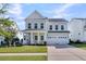 Charming two-story home with a welcoming front porch, lush lawn, and a convenient two-car garage, perfect for Gathering living at 292 Calm Water Way, Summerville, SC 29486