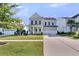 Beautiful two-story home with a classic front porch, manicured lawn, and vibrant landscaping, offering curb appeal at 292 Calm Water Way, Summerville, SC 29486