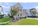 Beautifully landscaped two-story home with a charming front porch, a well-manicured lawn, and delightful curb appeal at 292 Calm Water Way, Summerville, SC 29486