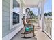 Relax on this charming front porch with rocking chairs and views of the neighborhood at 292 Calm Water Way, Summerville, SC 29486