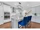 Kitchen with stainless steel appliances, granite countertops, white cabinets, bar seating, and hardwood floors at 292 Calm Water Way, Summerville, SC 29486