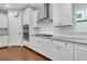 Bright kitchen with stainless steel appliances, white cabinets, subway tile backsplash, and granite countertops at 292 Calm Water Way, Summerville, SC 29486
