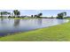 Scenic view of a serene lake surrounded by lush green grass and trees at 292 Calm Water Way, Summerville, SC 29486
