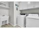 Clean laundry room featuring white washer and dryer, ample cabinet space, and a utility sink at 292 Calm Water Way, Summerville, SC 29486