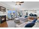 Bright living room featuring fireplace, large windows, hardwood floors, and open concept to kitchen with bar seating at 292 Calm Water Way, Summerville, SC 29486