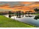 Picturesque lake reflecting homes and sky, surrounded by lush greenery, enhancing the community's charm at 292 Calm Water Way, Summerville, SC 29486