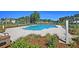 Inviting pool area surrounded by lush landscaping, with comfortable lounge chairs and a view of the lake at 292 Calm Water Way, Summerville, SC 29486