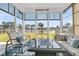 Bright sunroom offering panoramic lake views and comfortable seating for relaxation and enjoyment at 292 Calm Water Way, Summerville, SC 29486