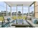 Inviting sunroom with comfortable seating and stunning lake views at 292 Calm Water Way, Summerville, SC 29486