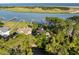 Stunning aerial view of a home with private docks on the water, surrounded by lush trees and greenery at 3121 Marshgate Dr, Seabrook Island, SC 29455
