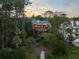 Aerial view showcases a house surrounded by lush greenery, blending into the natural landscape at 3121 Marshgate Dr, Seabrook Island, SC 29455