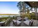 Outdoor seating on a wood balcony overlooking the waterfront views at 3121 Marshgate Dr, Seabrook Island, SC 29455