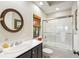 Bright bathroom with a glass-enclosed shower/tub combination and decorative mirror at 3121 Marshgate Dr, Seabrook Island, SC 29455