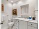 Well-lit half bathroom featuring stone countertops, a vanity, and decorative touches at 3121 Marshgate Dr, Seabrook Island, SC 29455