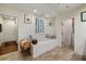 This bathroom offers a marble tub and a view out the window with wood shutters at 3121 Marshgate Dr, Seabrook Island, SC 29455