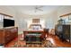 Well-lit bedroom with a ceiling fan, natural light, wood floors, and stylish decor at 3121 Marshgate Dr, Seabrook Island, SC 29455