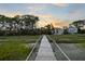 Picturesque wooden dock leading to waterfront homes, perfect spot to enjoy nature and waterfront views at 3121 Marshgate Dr, Seabrook Island, SC 29455