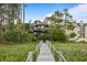 Stately home features a private walkway leading to lush landscaping at 3121 Marshgate Dr, Seabrook Island, SC 29455