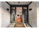 Elegant entryway with a beautiful front door, decorative lanterns, and glimpses of the home's interior at 3121 Marshgate Dr, Seabrook Island, SC 29455