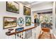 Stylish hallway with hardwood floors, elegant paintings, and a glimpse into a beautifully decorated dining area at 3121 Marshgate Dr, Seabrook Island, SC 29455