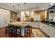 Modern kitchen featuring an island, brick accent walls, and stainless steel appliances at 3121 Marshgate Dr, Seabrook Island, SC 29455