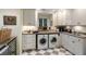 Clean, well-organized laundry room with ample storage and modern appliances at 3121 Marshgate Dr, Seabrook Island, SC 29455