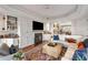 Stylish living room featuring built-in shelving, hardwood floors, and a decorative fireplace at 3121 Marshgate Dr, Seabrook Island, SC 29455