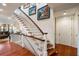 This staircase features white wood and dark wood accents, and beautiful artwork on the wall at 3121 Marshgate Dr, Seabrook Island, SC 29455
