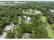 Aerial view of a neighborhood near a golf course surrounded by a beautiful canopy of trees and ponds at 3226 Waverly Ln, Johns Island, SC 29455