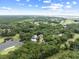 Aerial view showcases the community, golf course and homes surrounded by trees at 3226 Waverly Ln, Johns Island, SC 29455