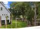 Backyard view shows mature trees and green lawn with the side of the house at 3226 Waverly Ln, Johns Island, SC 29455