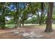 Scenic backyard view with mature trees, leading to a golf course offering a picturesque and tranquil setting at 3226 Waverly Ln, Johns Island, SC 29455