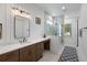 Elegant bathroom with wood-look vanity, dual mirrors, walk-in shower, and tile flooring at 3226 Waverly Ln, Johns Island, SC 29455