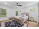 Cozy bedroom featuring a tufted headboard bed, ceiling fan, and natural light from windows at 3226 Waverly Ln, Johns Island, SC 29455