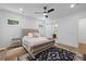 Comfortable bedroom features a tufted headboard, ceiling fan, and an ensuite bathroom with a sliding barn door at 3226 Waverly Ln, Johns Island, SC 29455