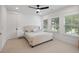 Inviting bedroom with ample natural light, plush carpeting, and a stylish upholstered headboard at 3226 Waverly Ln, Johns Island, SC 29455