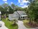 Beautifully landscaped home with lush lawn, mature trees, and a long driveway enhancing curb appeal at 3226 Waverly Ln, Johns Island, SC 29455